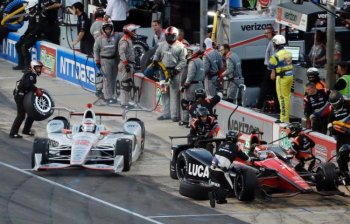 Will Power (12), of Australia, speeds out of his stall after a pit stop past Mikhail Aleshin (7), of Russia, during an IndyCar auto race at Texas Motor Speedway, Saturday, June 10, 2017, in Fort Worth, Texas. (AP Photo/Tony Gutierrez)